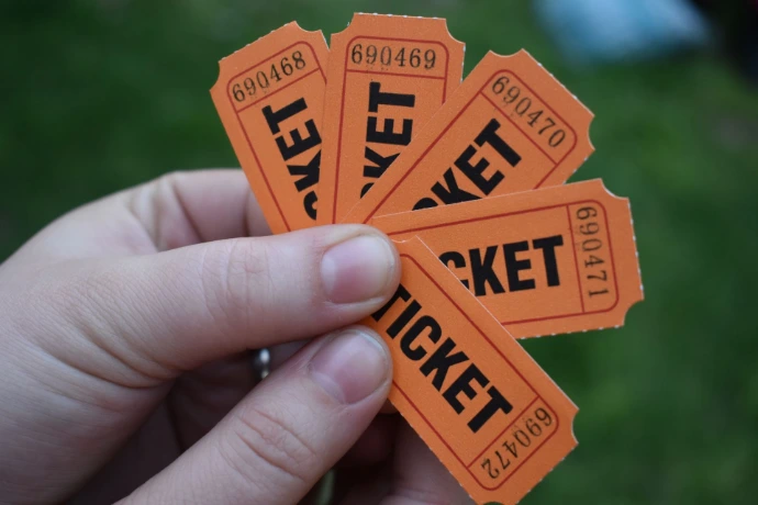 hand holding raffle tickets